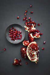 Pomegranate and pomegranate seeds in bowl - ASF06146