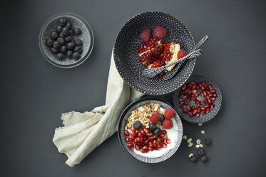 Muesli with pomegranate seeds and different berries in bowl - ASF06147