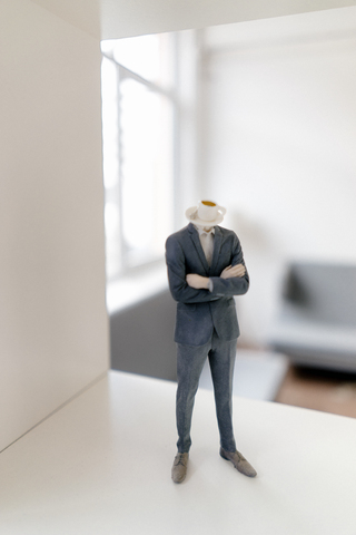 Geschäftsmann Figur mit Kaffeetasse Kopf stehend im Büro, lizenzfreies Stockfoto