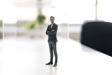 Geschäftsmann Figur stehend auf dem Schreibtisch im modernen Büro - FLAF00081