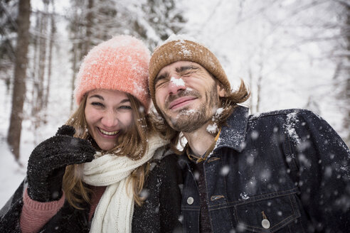 Happy couple having fun with snow in winter landscape - SUF00437