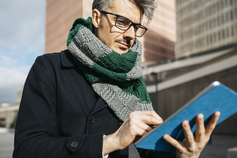 Portrait of businessman using tablet outdoors stock photo