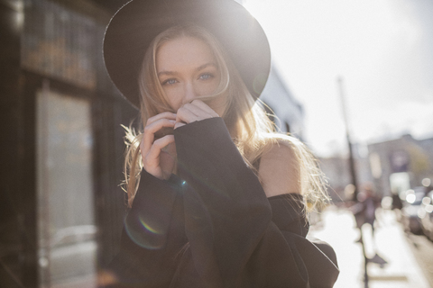 Portrait of woman with hat dressed in black at backlight stock photo