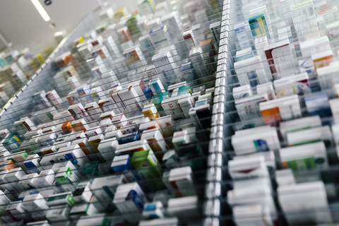 Medicine in shelves in commissioning machine in pharmacy stock photo