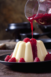 Custard with raspberries and raspberry sauce on plate - CSF28730