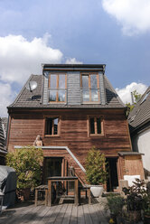 Woman sunbathing on back side of her house - KNSF03474