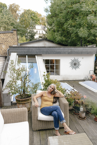 Woman relaxing on terrace stock photo