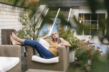 Frau entspannt auf Terrasse - KNSF03528