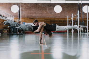 Two men doing acrobatics in gym - OCAF00005