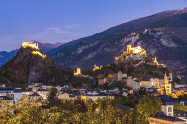 Switzerland, Canton Vaud, Sion, townscape with Tourbillon Castle, Notre-Dame de Valere and Notre Dame du Glarier at dusk - WDF04311