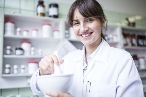 Portrait of smiling woman working in laboratory of a pharmacy stock photo