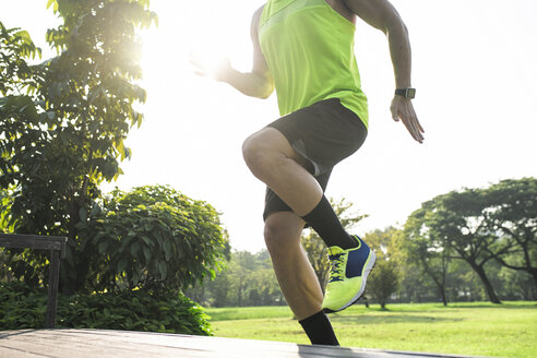 Runner training running up stairs, close up - SBOF01131