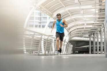 Fit man running on a bridge in the city - SBOF01158