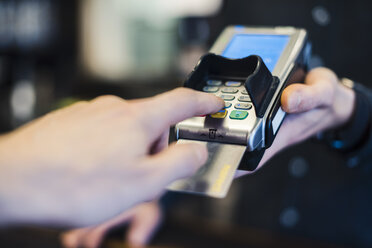 Man using credit card reader, close-up - DIGF03223