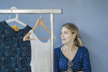 Portrait of smiling fashion designer in her studio - JOSF02125