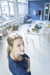 Portrait of smiling woman in a loft - JOSF02134