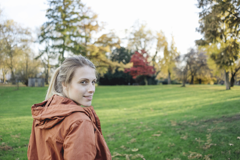 Portrait of young woman in autumnal park stock photo