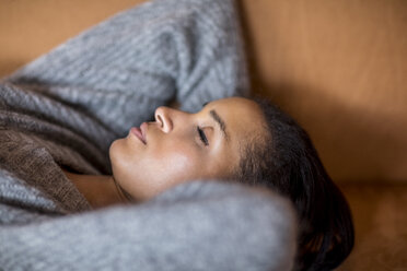 Portrait of sleeping young woman on couch - FMKF04685