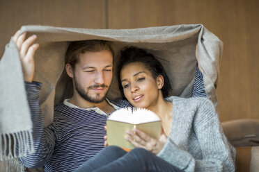 Portrait of young couple relaxing together at home - FMKF04723