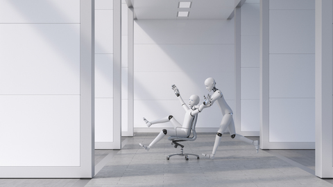 Robot pushing a cheering friend on a chair through the office stock photo