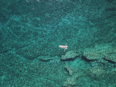 Stara Baška, Krk, Croatia, woman floating on water stock photo