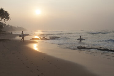 Sri Lanka, Mirissa, sunrise, beach with surfer - FAF00075