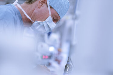 Neurosurgeon in scrubs looking down - MWEF00188