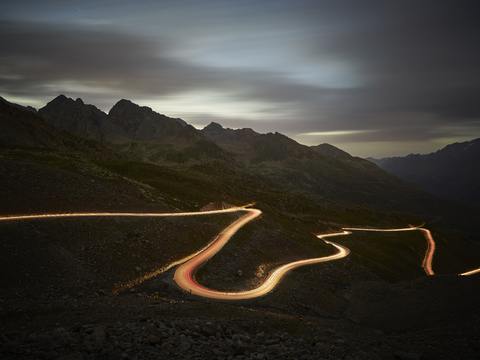 Austria, Tyrol, Kaunertal, road in the evening, light trails stock photo