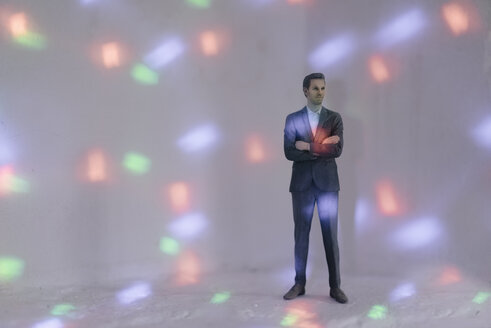 Miniature businessman figurine surrounded by points of light - FLAF00133