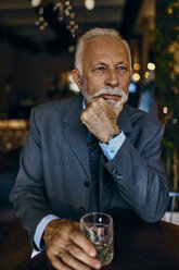 Portrait of elegant senior man in a bar with tumbler - ZEDF01168