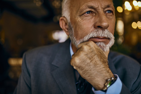 Portrait of elegant senior man thinking stock photo