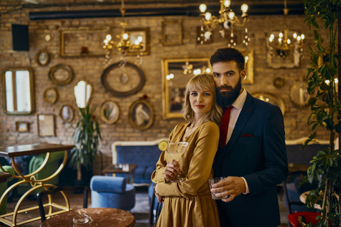 Portrait of elegant couple with drinks in a bar stock photo