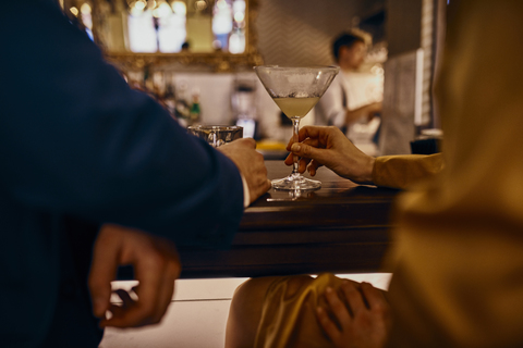 Close-up of elegant couple having a drink at the counter in a bar stock photo