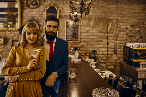 Portrait of elegant couple with drinks in a bar stock photo