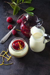 Glass of pudding with vanilla sauce and raspberry sauce garnished with raspberry and orange zest - CSF28750