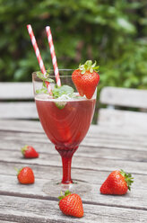 Strawberry lemonade in glass with drinking straws - GWF05387