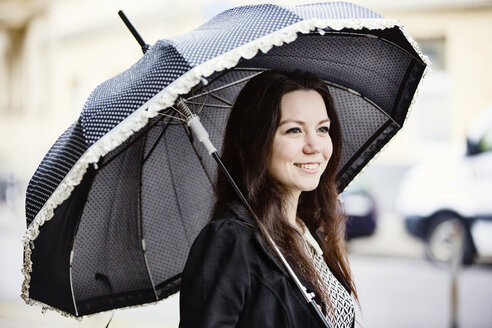 Portrait of fashionable young woman with black vintage umbrella - JATF00995