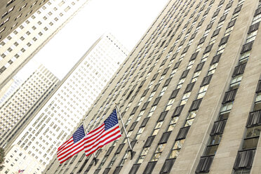 USA, New York City, Manhattan, skyscraper with American flags - CMF00775