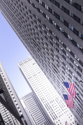 USA, New York City, Manhattan, skyscraper with American flags - CMF00777