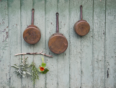 Copper saucepans, sage, rosemary, cress stock photo