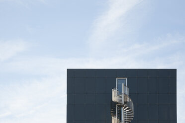 Germany, Munich, facade of modern office building with spiral staircase - FCF01333