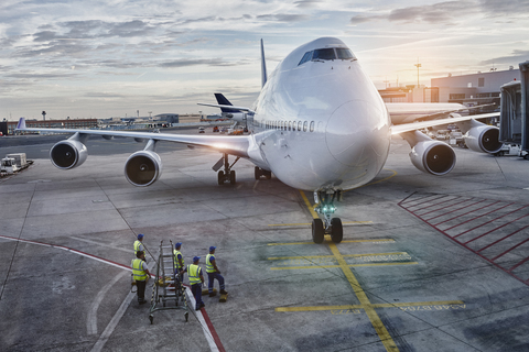 Airplane on the apron at sunset stock photo