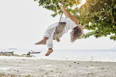 Thailand, Phi Phi Islands, Ko Phi Phi, little girl on a rope swing on the beach - RORF01102