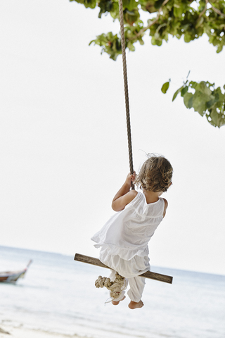 Thailand, Phi Phi Islands, Ko Phi Phi, little girl on a rope swing on the beach stock photo