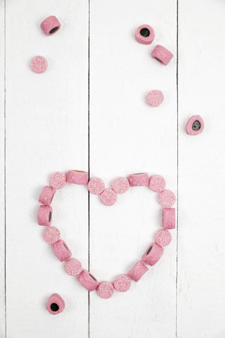 British licorice, heart on wooden background stock photo