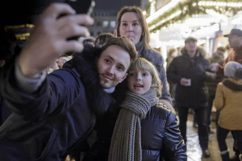 Family taking selfie with smartphone at Christmas market stock photo