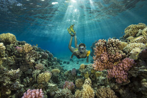 Egypt, Red Sea, Hurghada, teenage girl snorkeling at coral reef - YRF00190
