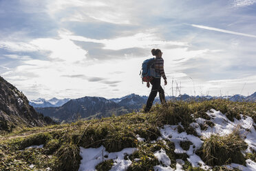 Austria, Tyrol, young woman hiking in the mountains - UUF12539