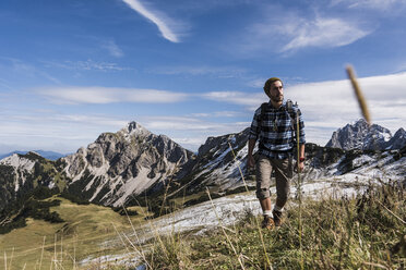 Austria, Tyrol, young man hiking in the mountains - UUF12549