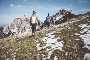 Austria, Tyrol, three hikers walking in the mountains - UUF12585